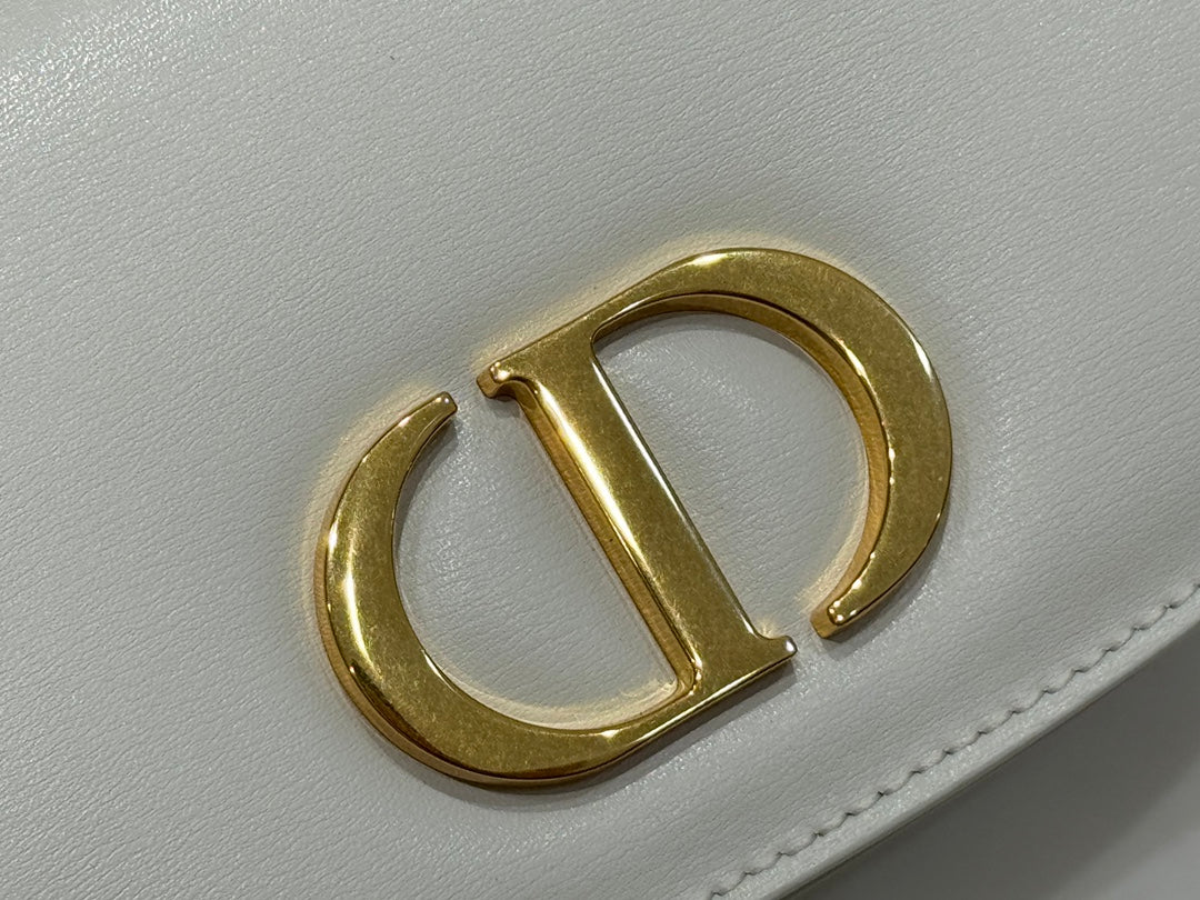 Luxury White Leather Top Handle Handbag with Gold-Tone Signature Logo and Adjustable Strap